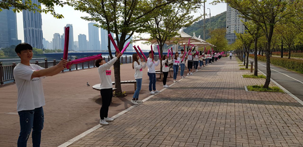 참여자들을 맞이 하기 위해 스텝들이 막대풍선을 들고 맞이할 준비를 하고 있는 모습