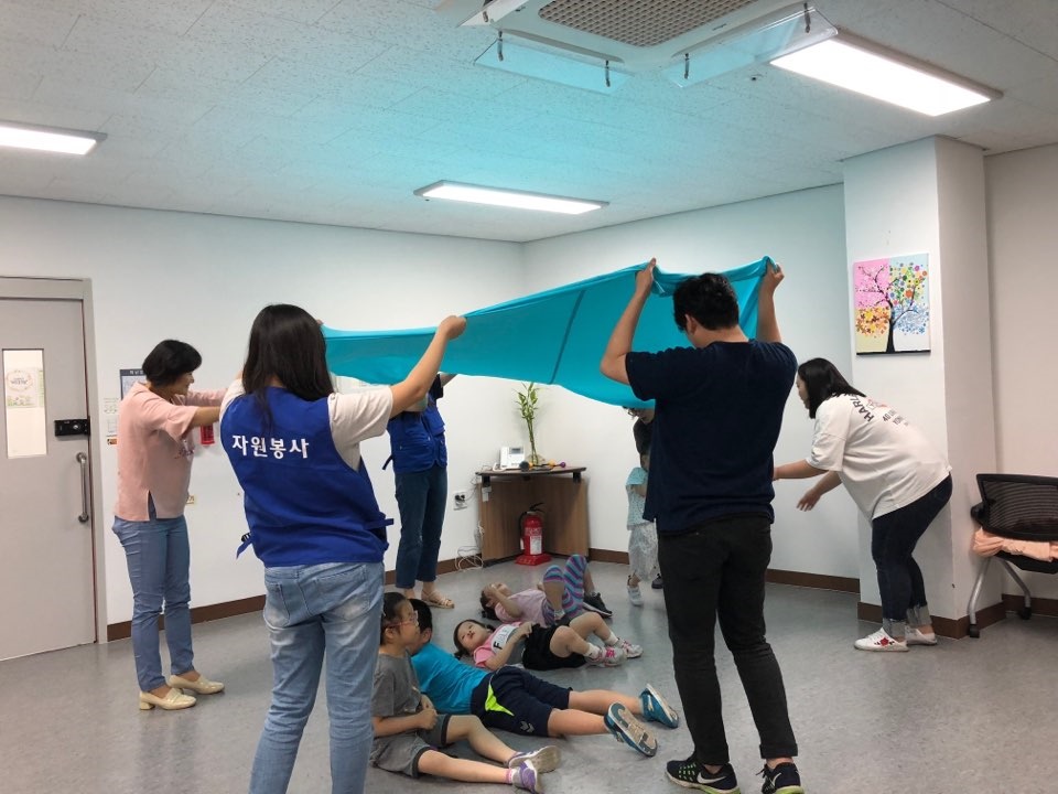 무용교실에 참여한 아이들이 바닥에 누워 프로그램을 즐기고 있는 모습